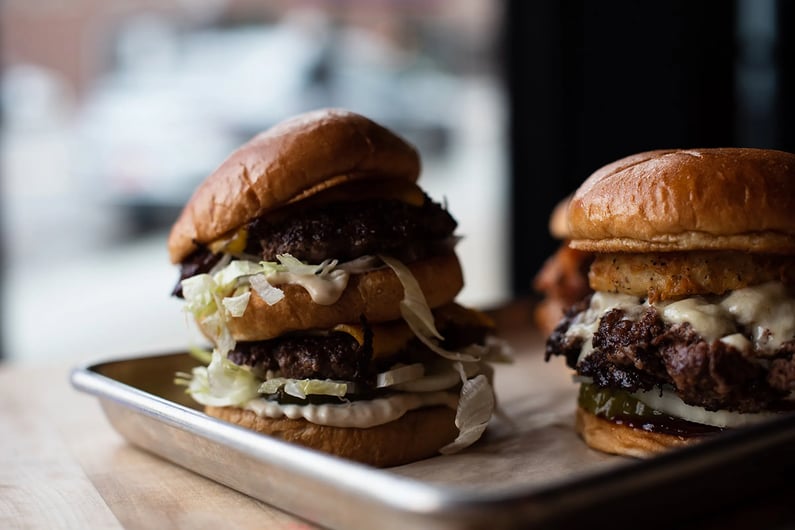 Two cheeseburgers on a tray